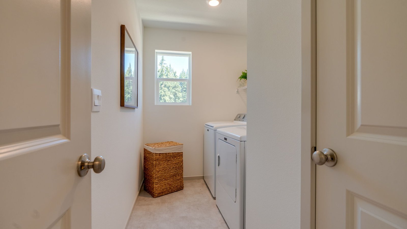 Laundry room with wire shelves and washer and dryer hookups
