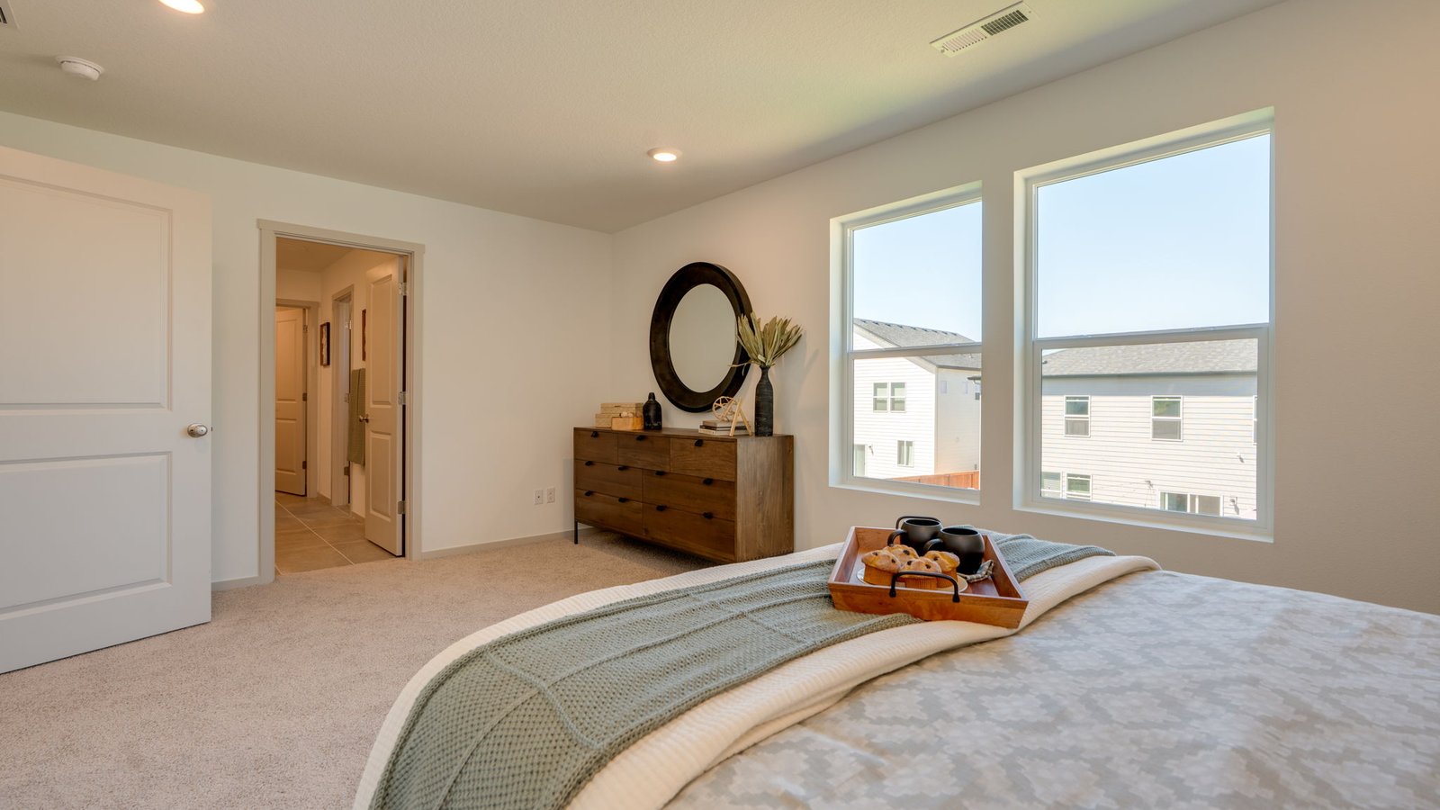 Primary bedroom with wall-to-wall carpet, a walk-in closet and an attached bathroom