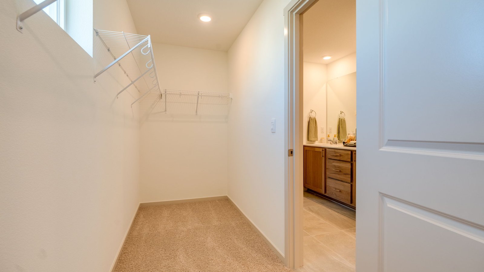 Primary bedroom walk-in closet with wire shelves