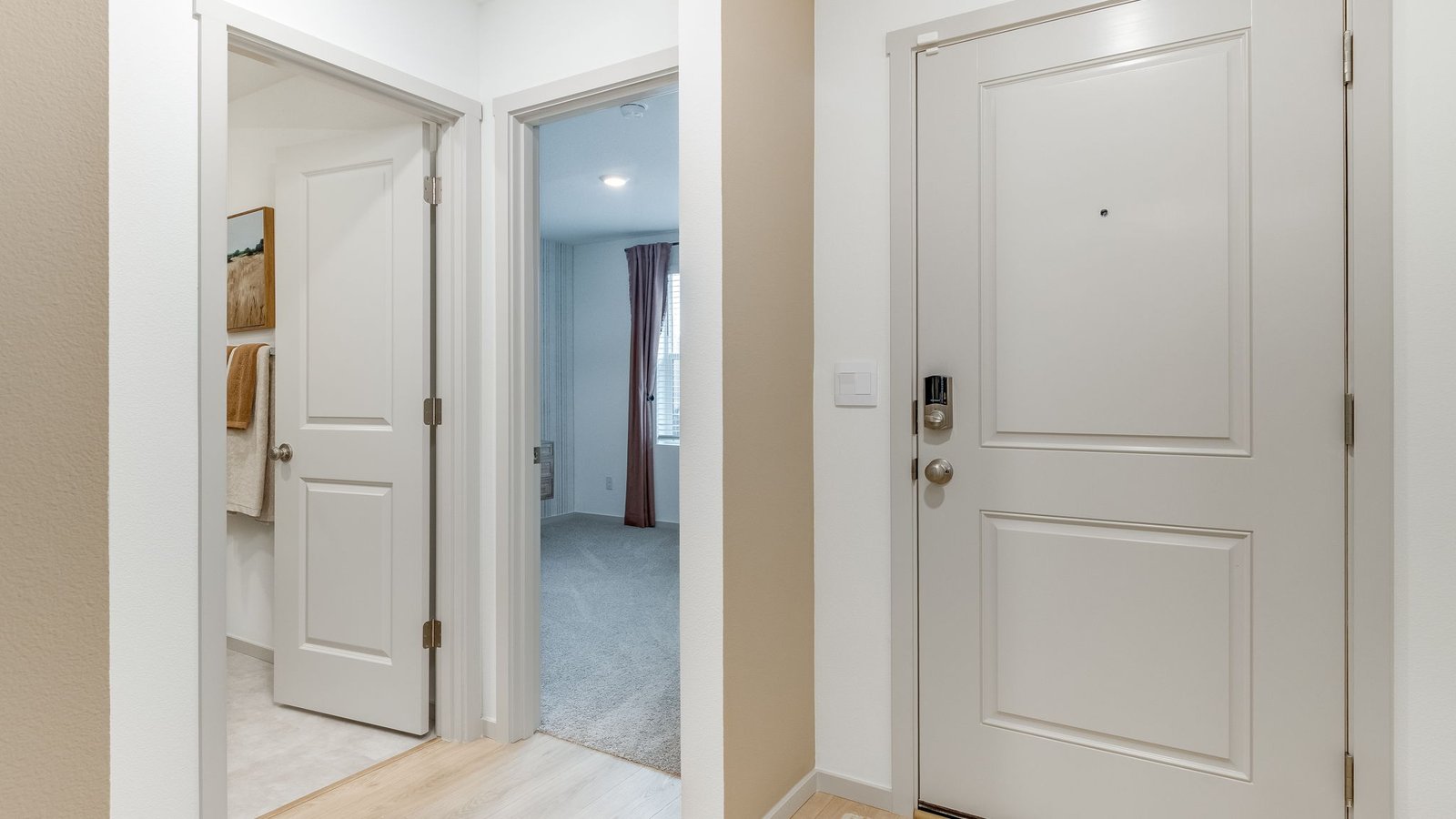 Entryway with a coat closet and laminate flooring