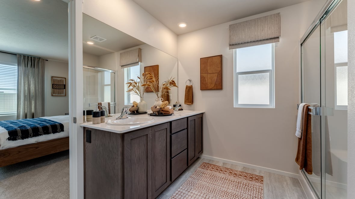 Primary bathroom with quartz counters and a walk-in shower