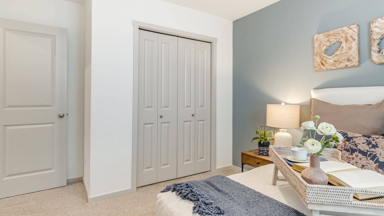 Bedroom with wall-to-wall carpet and a closet