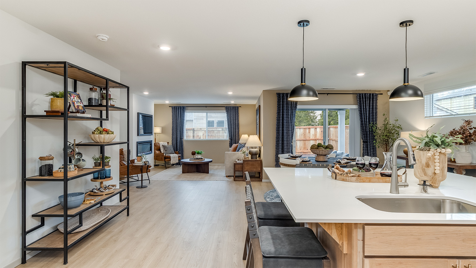 Kitchen with shaker cabinets, quartz counters, stainless steel appliances, pantry, and an island with a breakfast bar