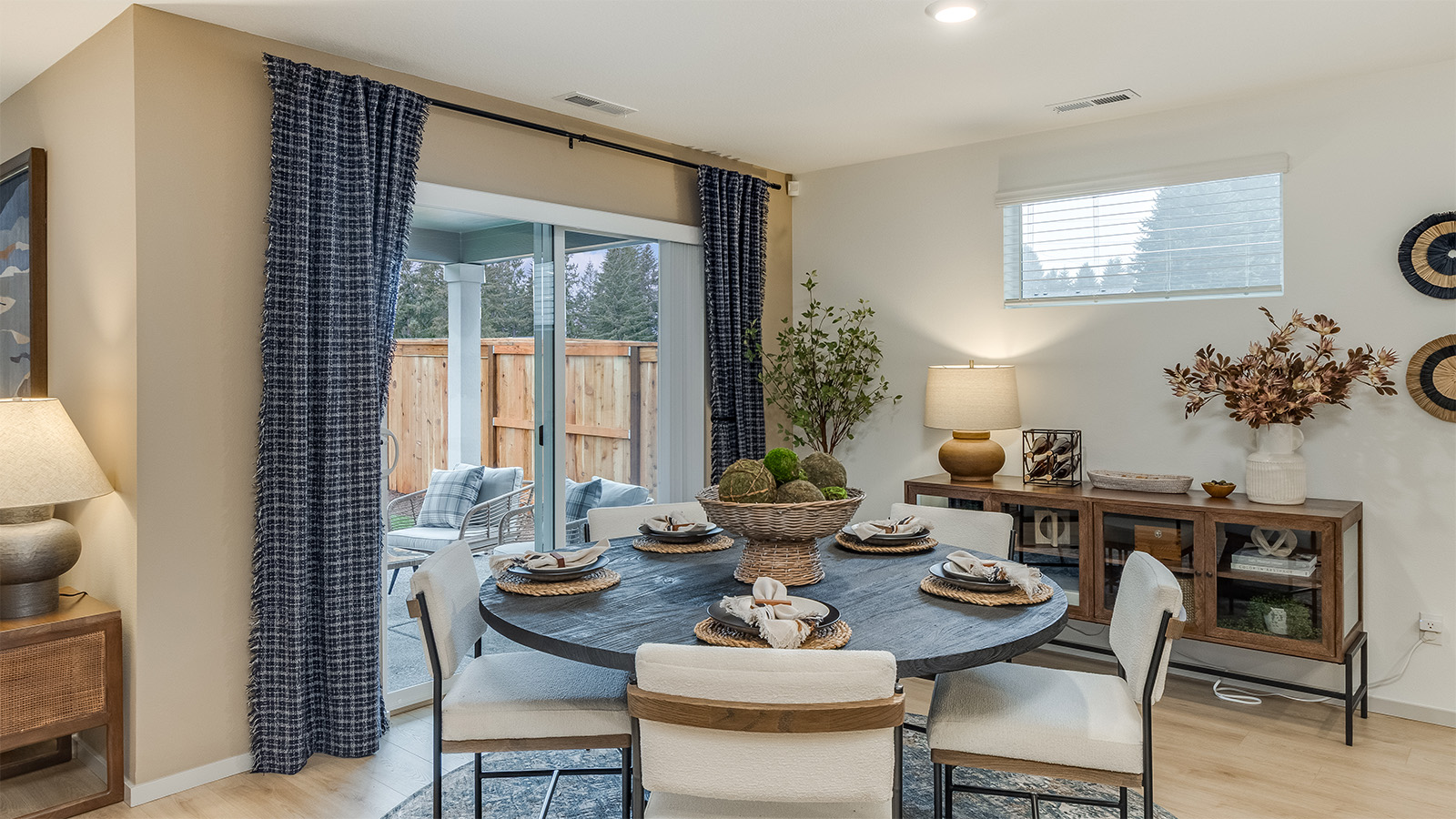 Dining area with a sliding glass door to a fenced backyard