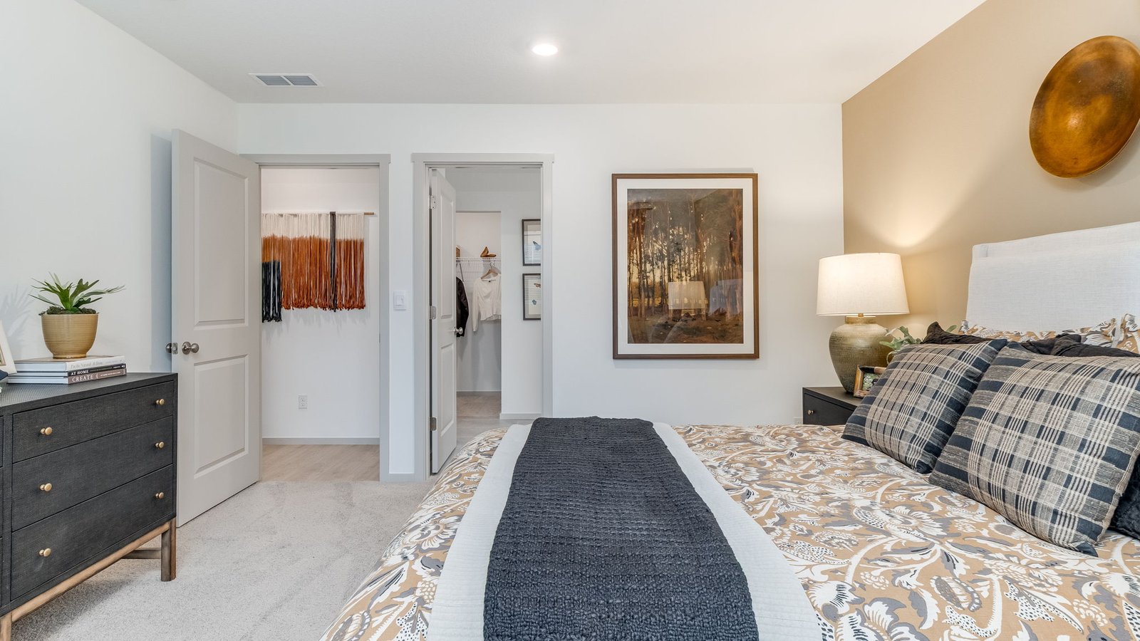Primary bedroom with wall-to-wall carpet, a walk-in closet and an attached bathroom