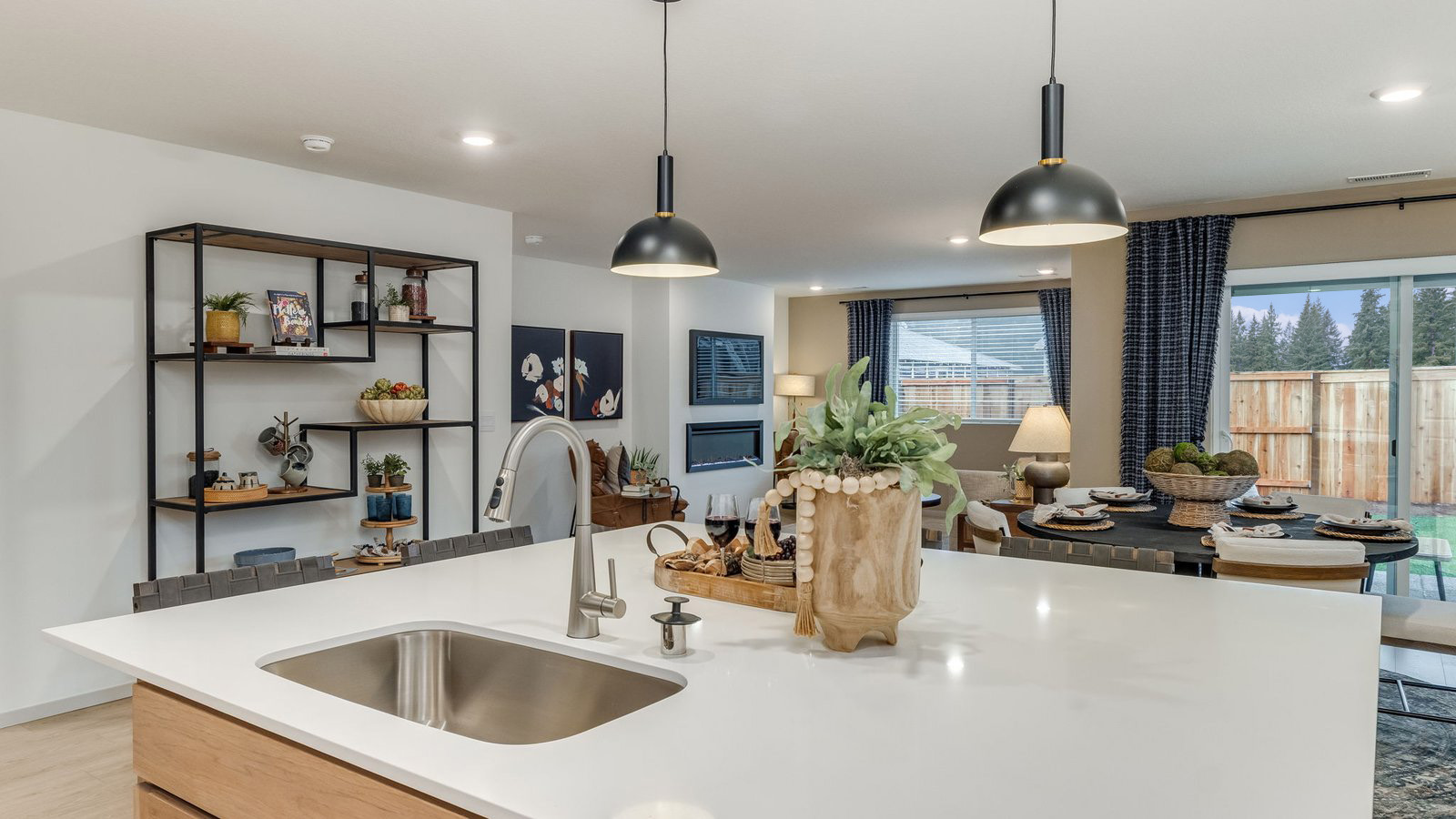 Kitchen with shaker cabinets, quartz counters, stainless steel appliances, pantry, and an island with a breakfast bar
