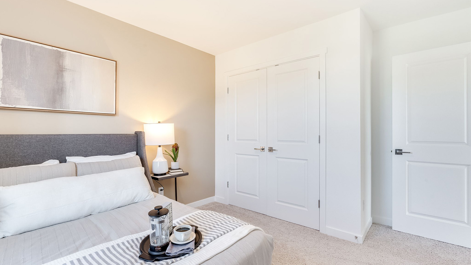 Bedroom with wall-to-wall carpet and a closet