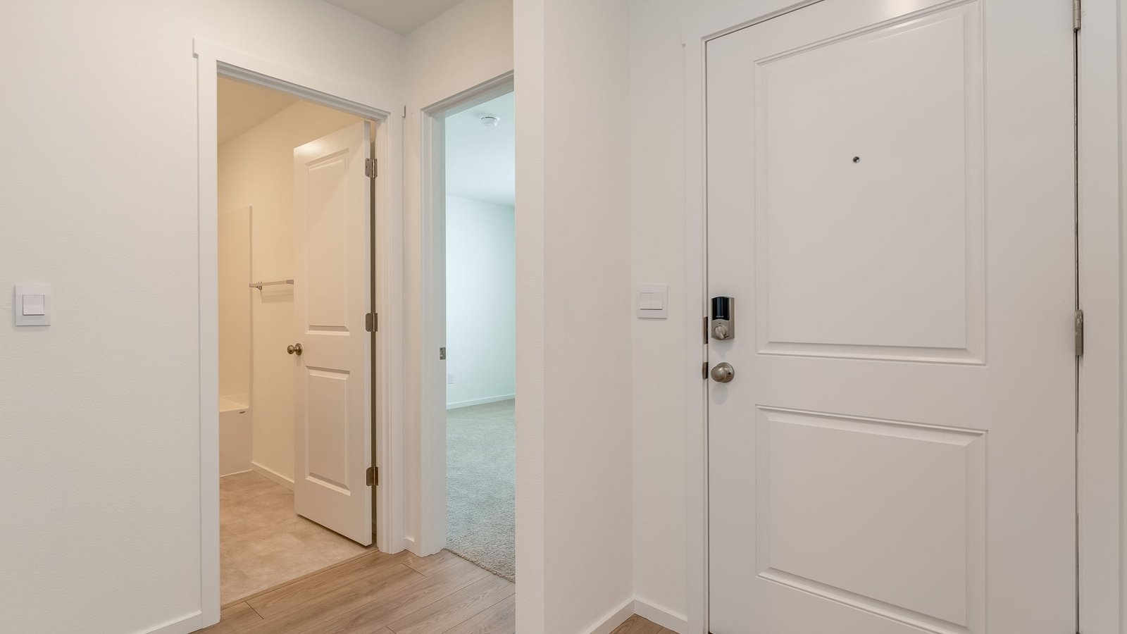 Entryway with a coat closet and laminate flooring
