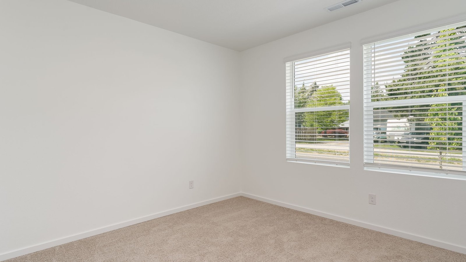 Bedroom with wall-to-wall carpet and a closet