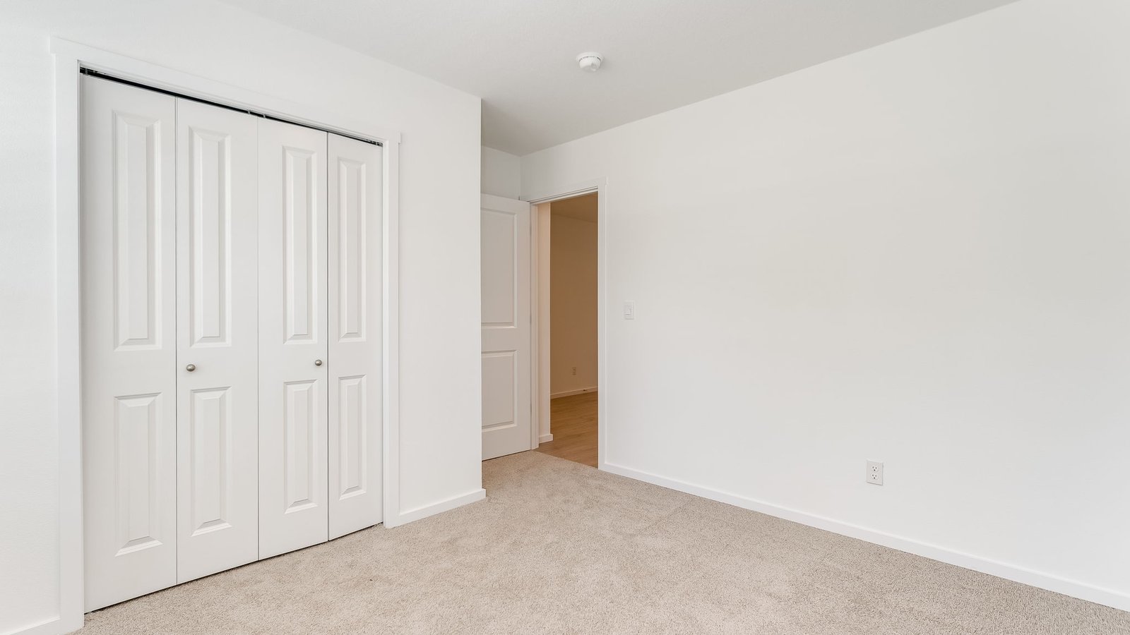 Bedroom with wall-to-wall carpet and a closet