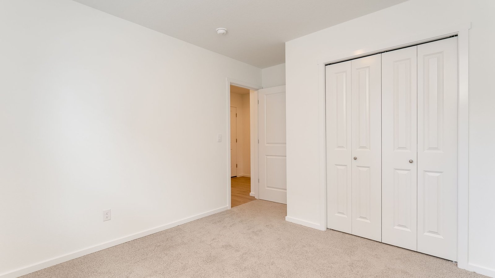 Bedroom with wall-to-wall carpet and a closet