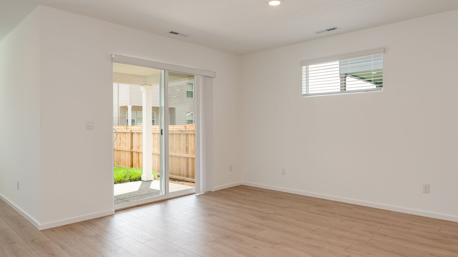 Dining area with a sliding glass door to a fenced backyard