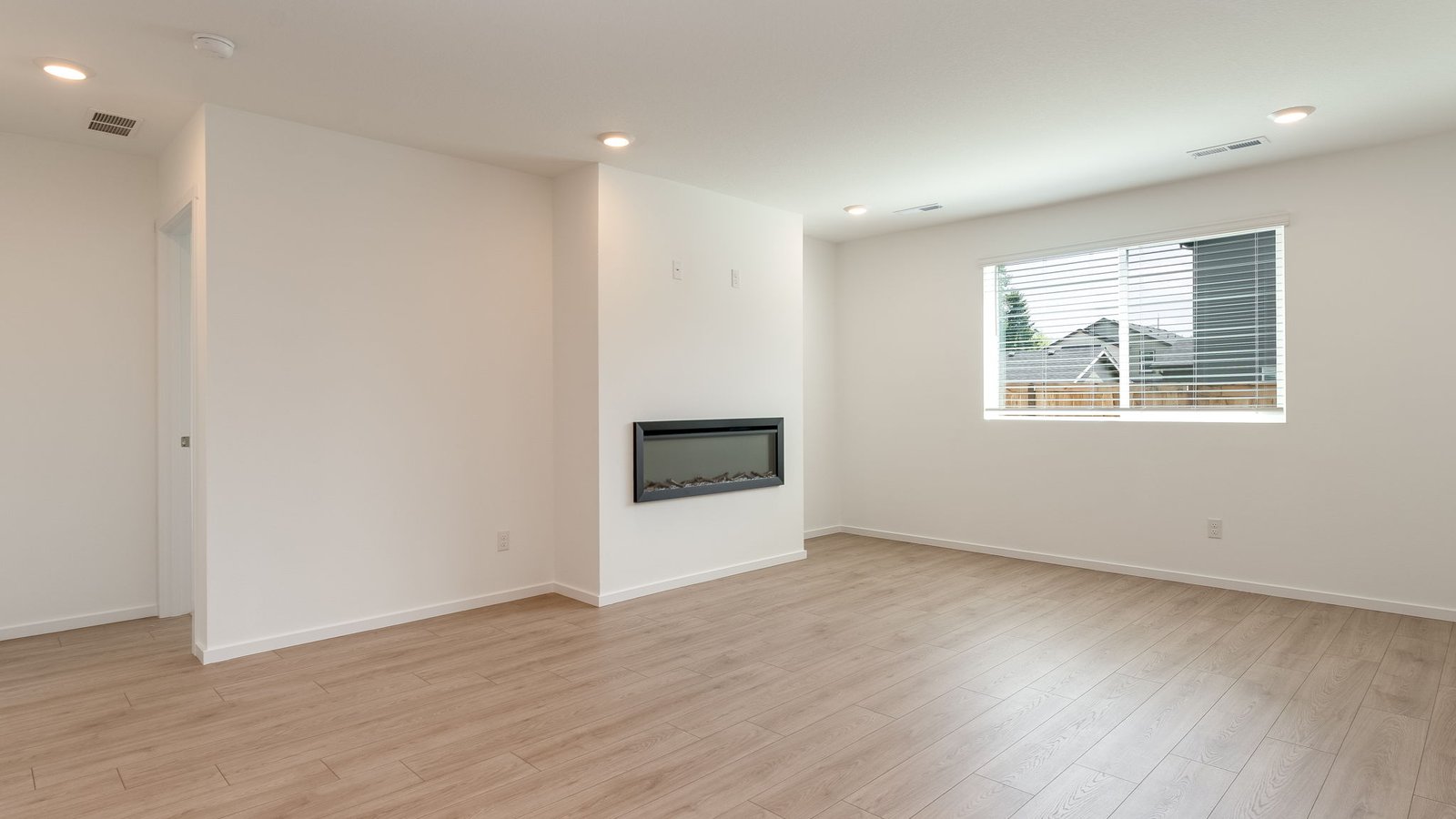 Great room with laminate flooring and an electric fireplace