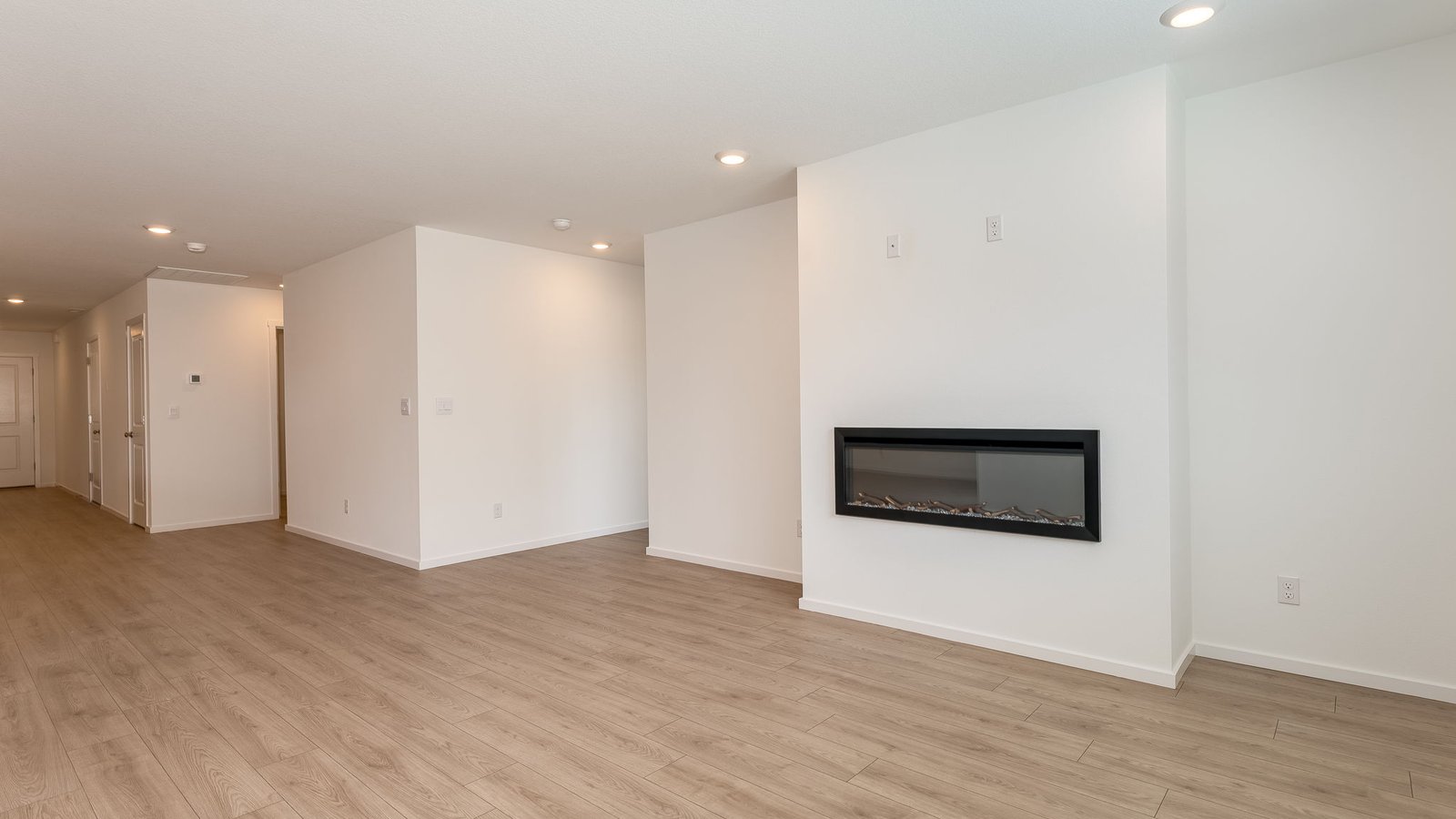 Great room with laminate flooring and an electric fireplace