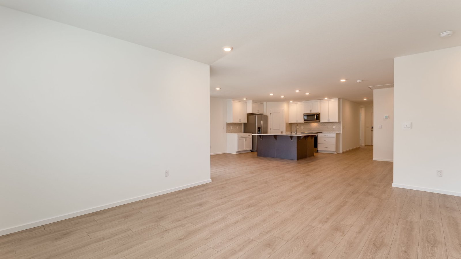Great room with laminate flooring and an electric fireplace