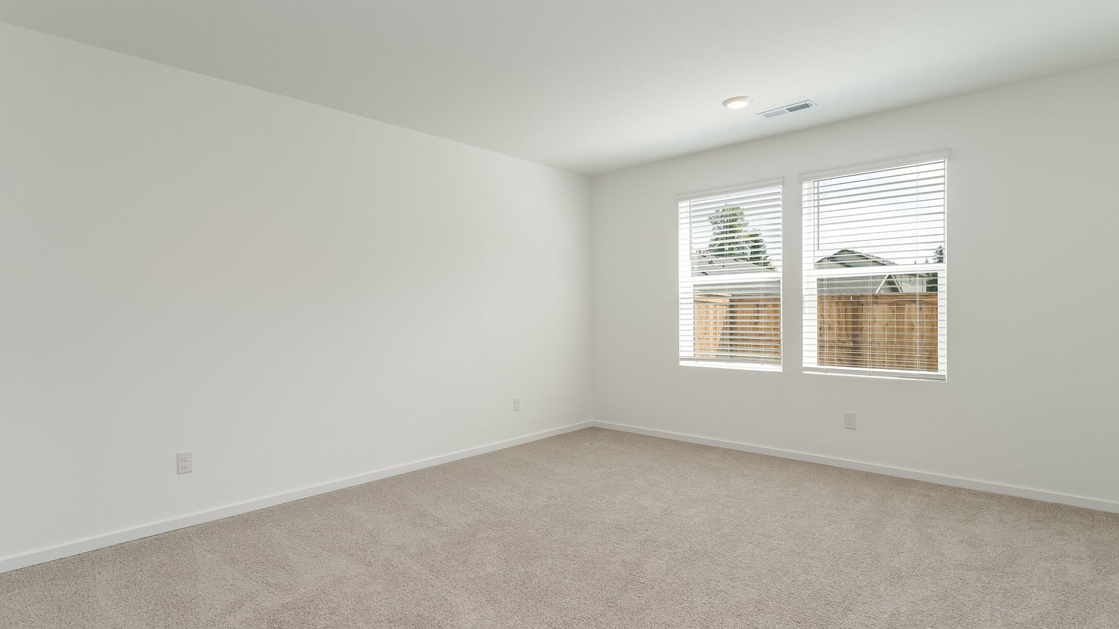 Primary bedroom with wall-to-wall carpet, a walk-in closet and an attached bathroom