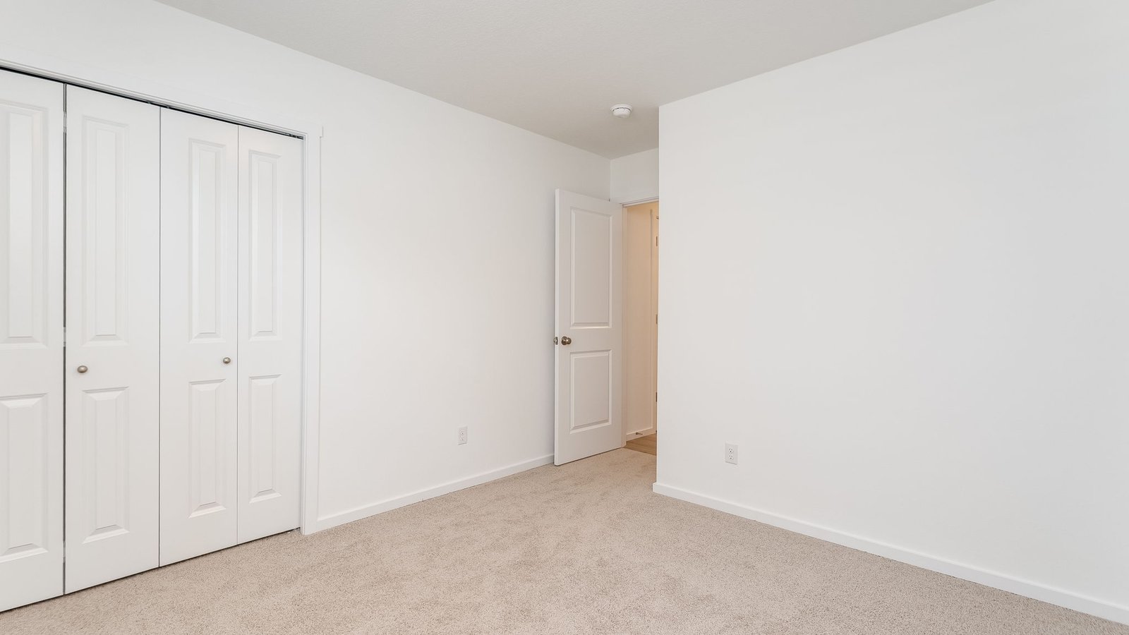 Bedroom with wall-to-wall carpet and a closet