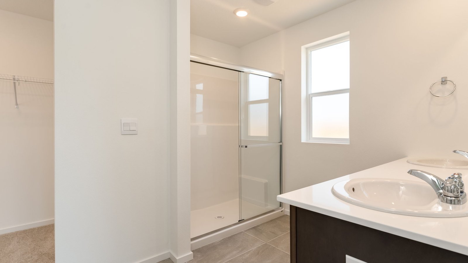 Primary bathroom with quartz counters and a walk-in shower
