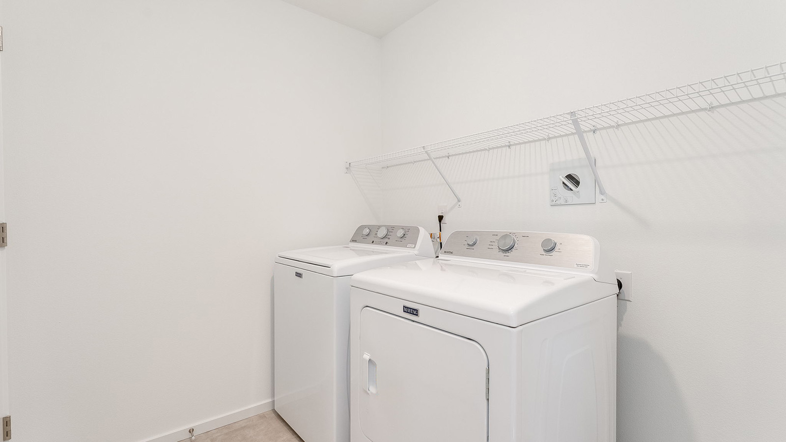 Laundry room with wire shelves and washer and dryer hookups