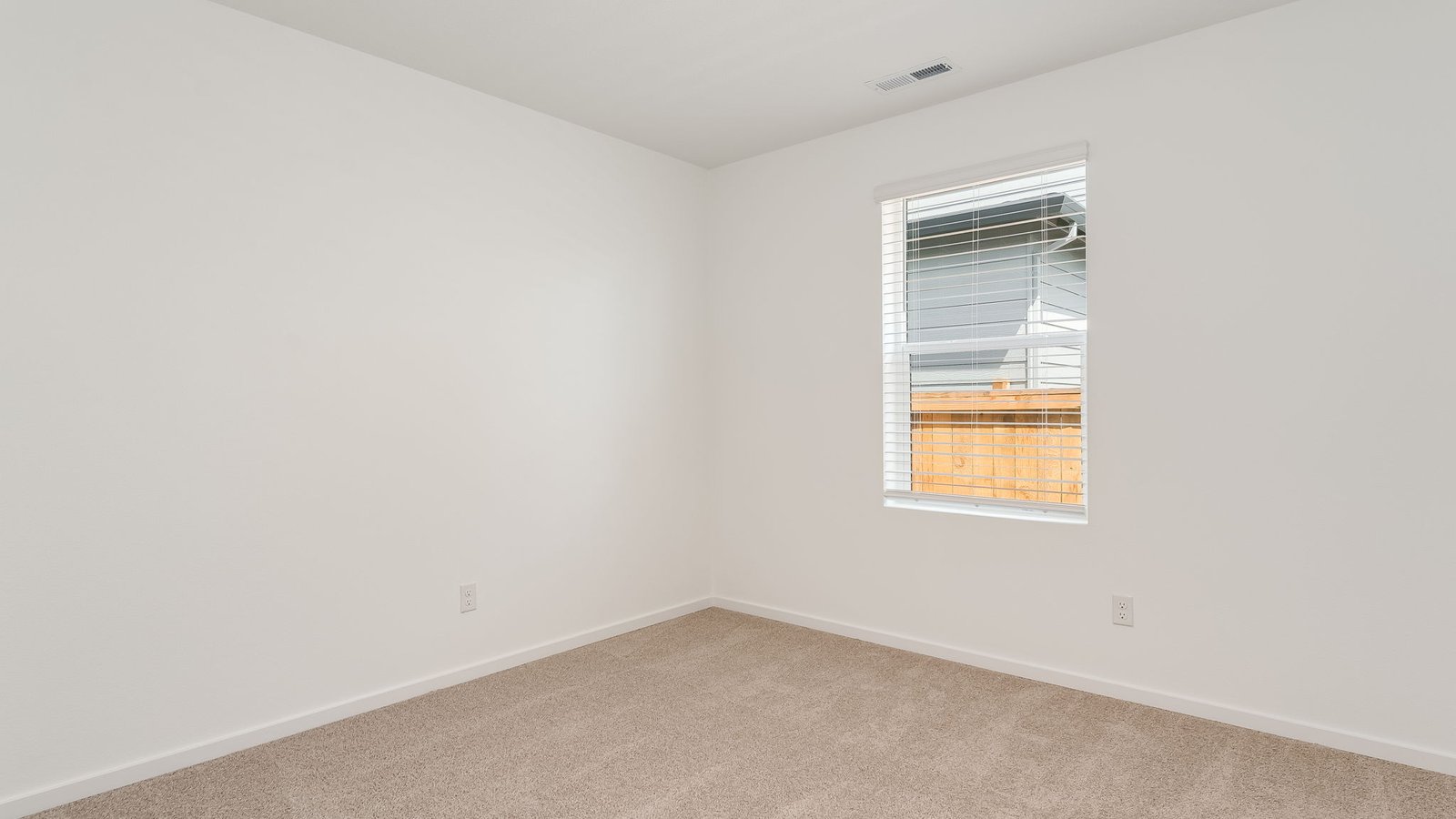 Bedroom with wall-to-wall carpet and a closet