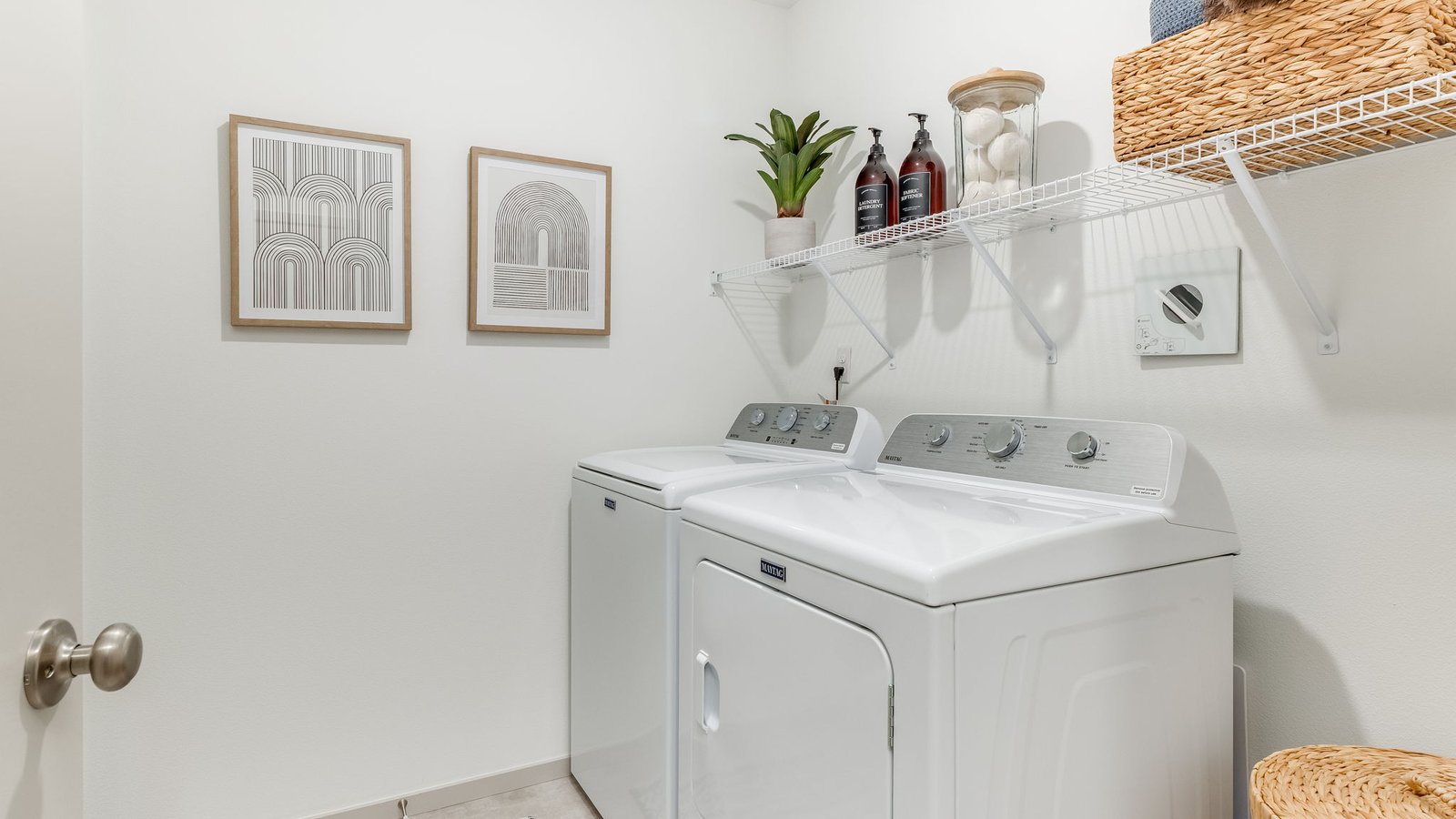 Laundry room with wire shelves and washer and dryer hookups