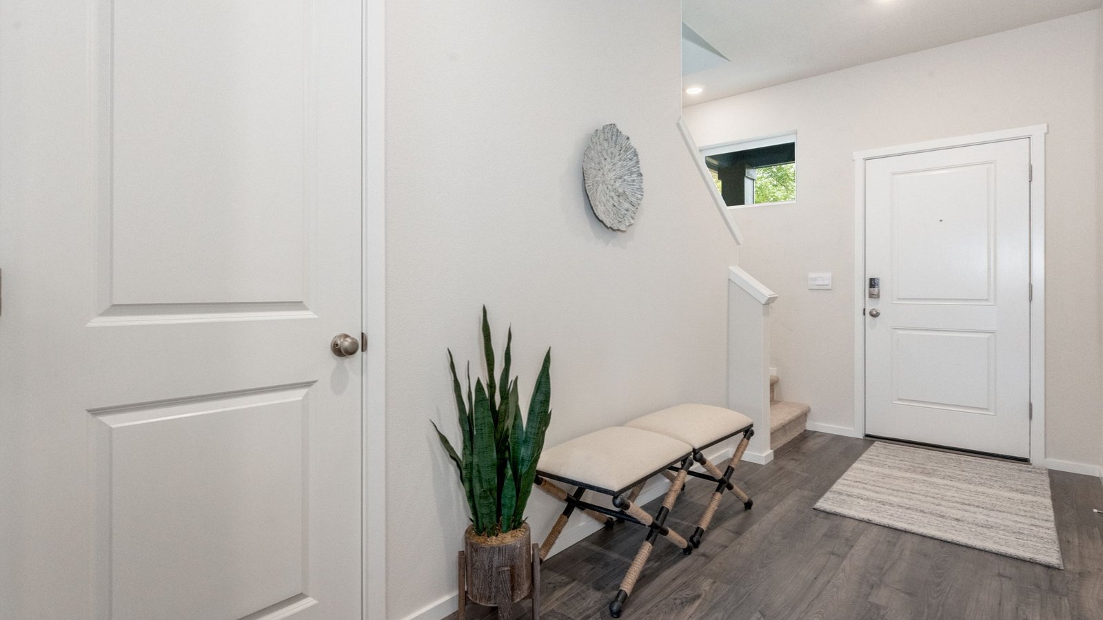 Entryway with a coat closet and laminate flooring
