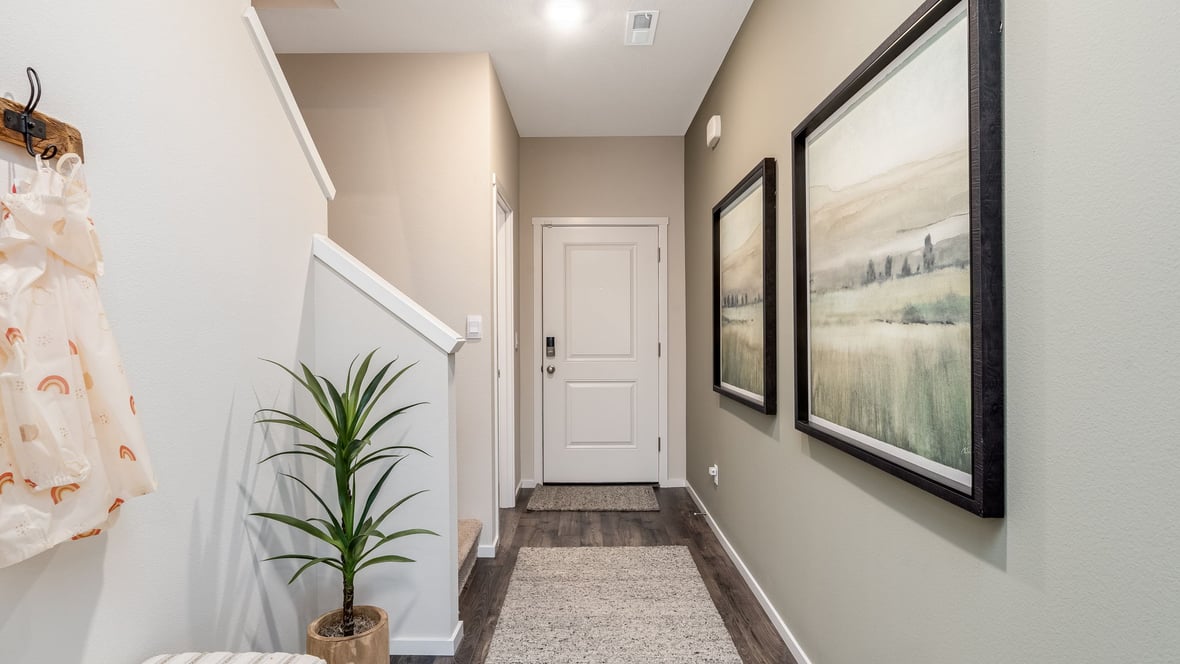 Entryway with a coat closet and laminate flooring