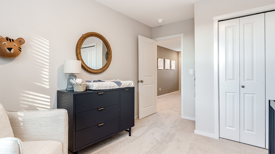 Bedroom with wall-to-wall carpet and a closet