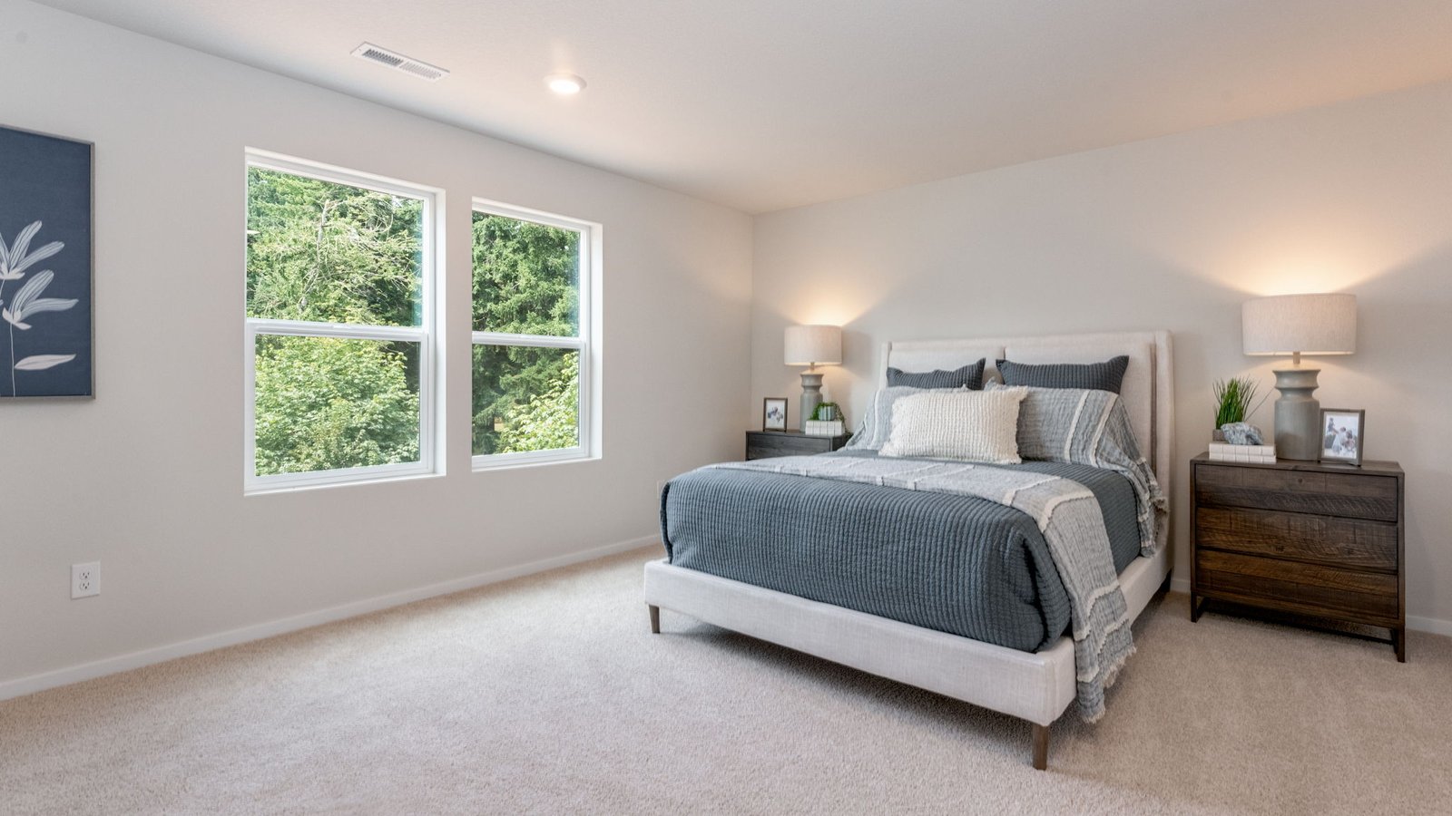 Primary bedroom with wall-to-wall carpet, a walk-in closet and an attached bathroom
