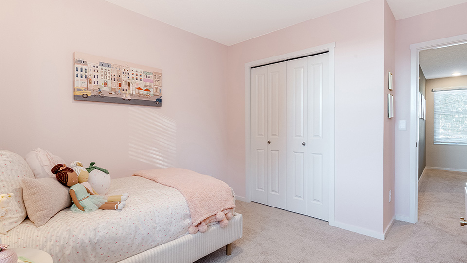 Bedroom with wall-to-wall carpet and a closet