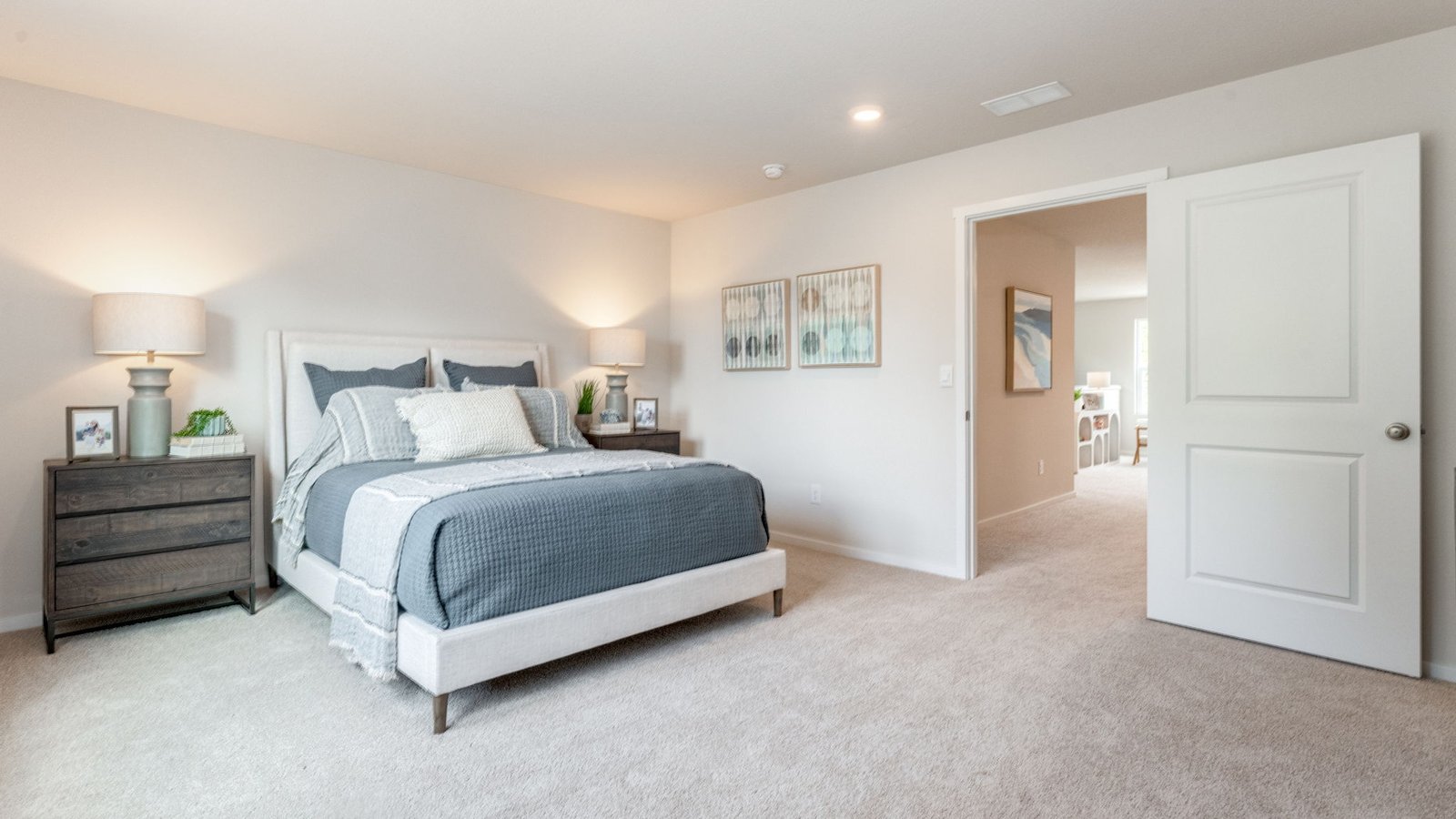 Primary bedroom with wall-to-wall carpet, a walk-in closet and an attached bathroom