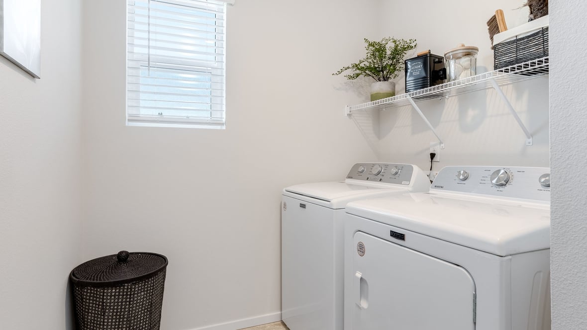 Laundry room with wire shelves and washer and dryer hookups