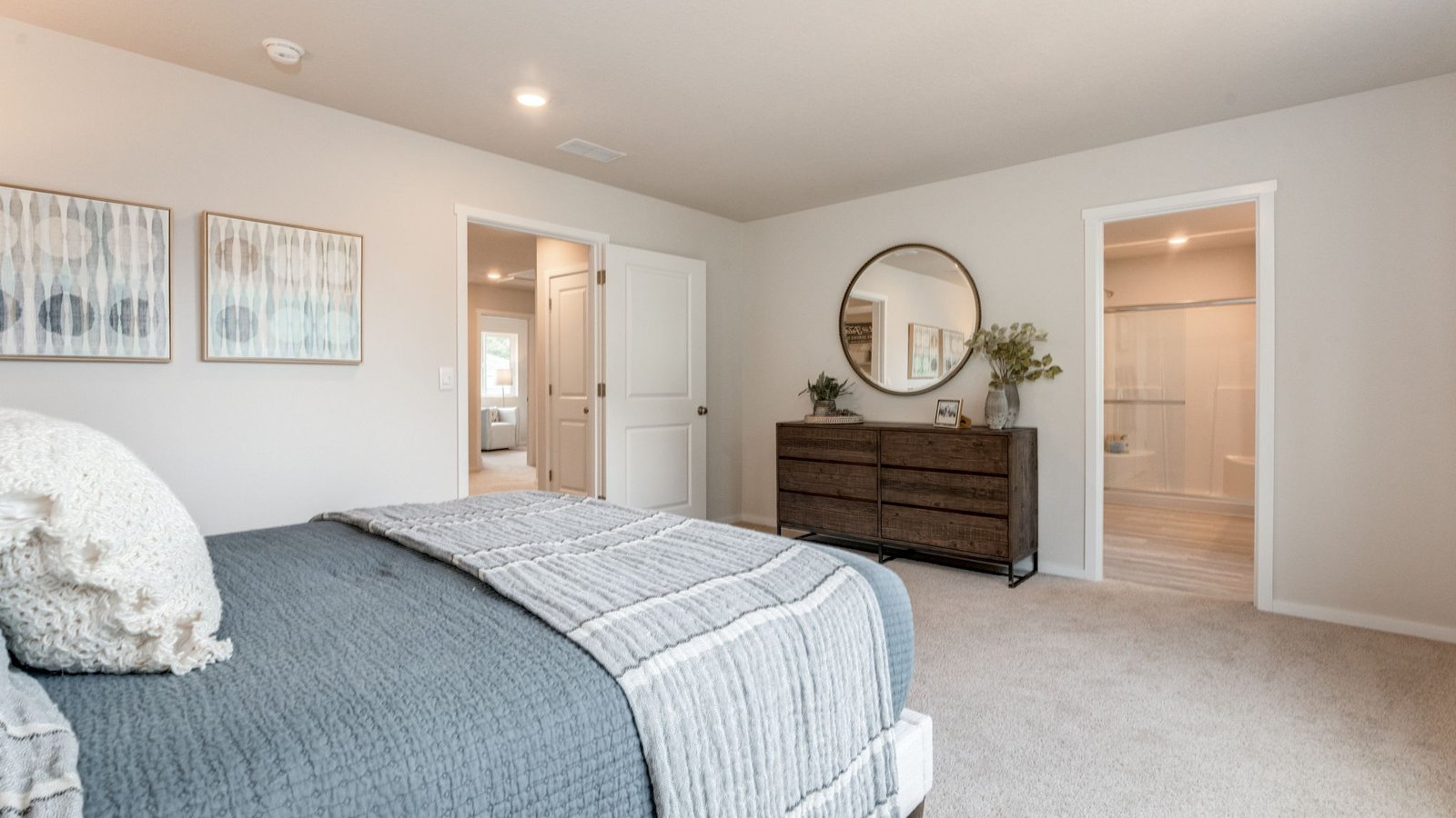 Primary bedroom with wall-to-wall carpet, a walk-in closet and an attached bathroom