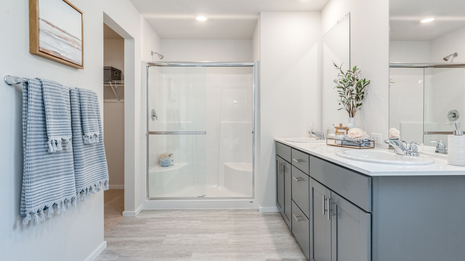 Primary bathroom with quartz counters and a walk-in shower
