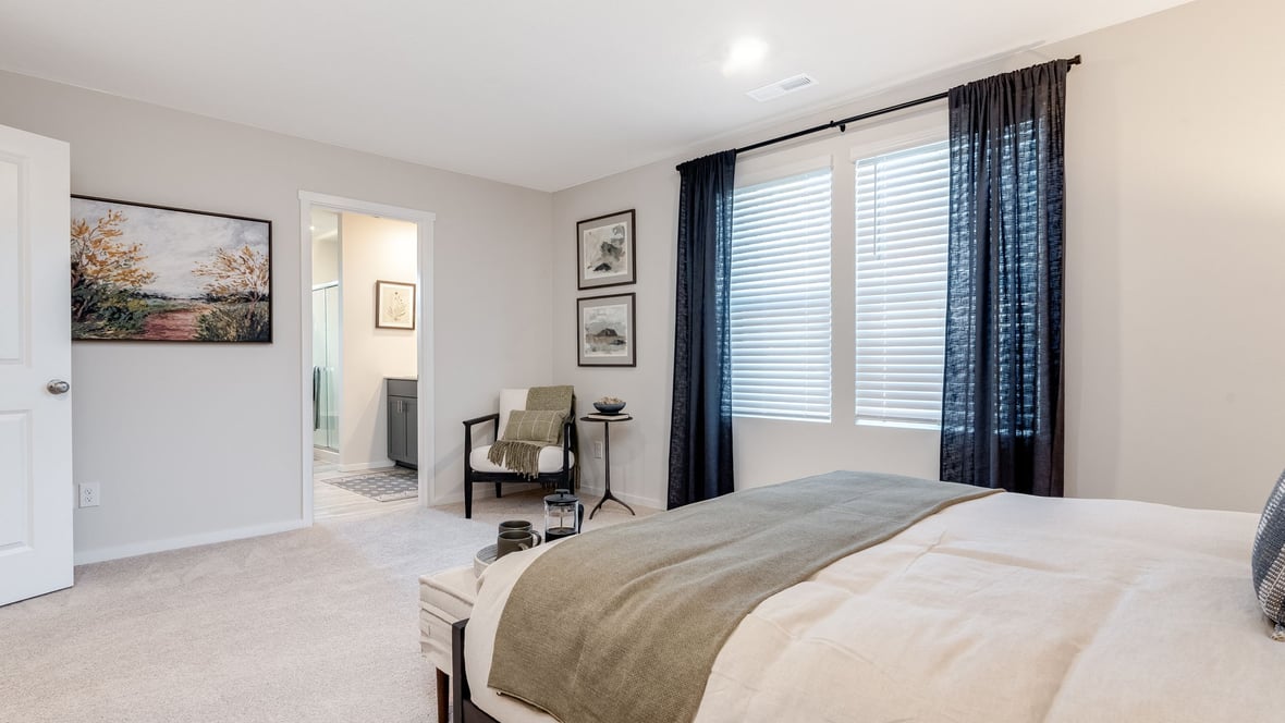 Primary bedroom with wall-to-wall carpet, a walk-in closet and an attached bathroom