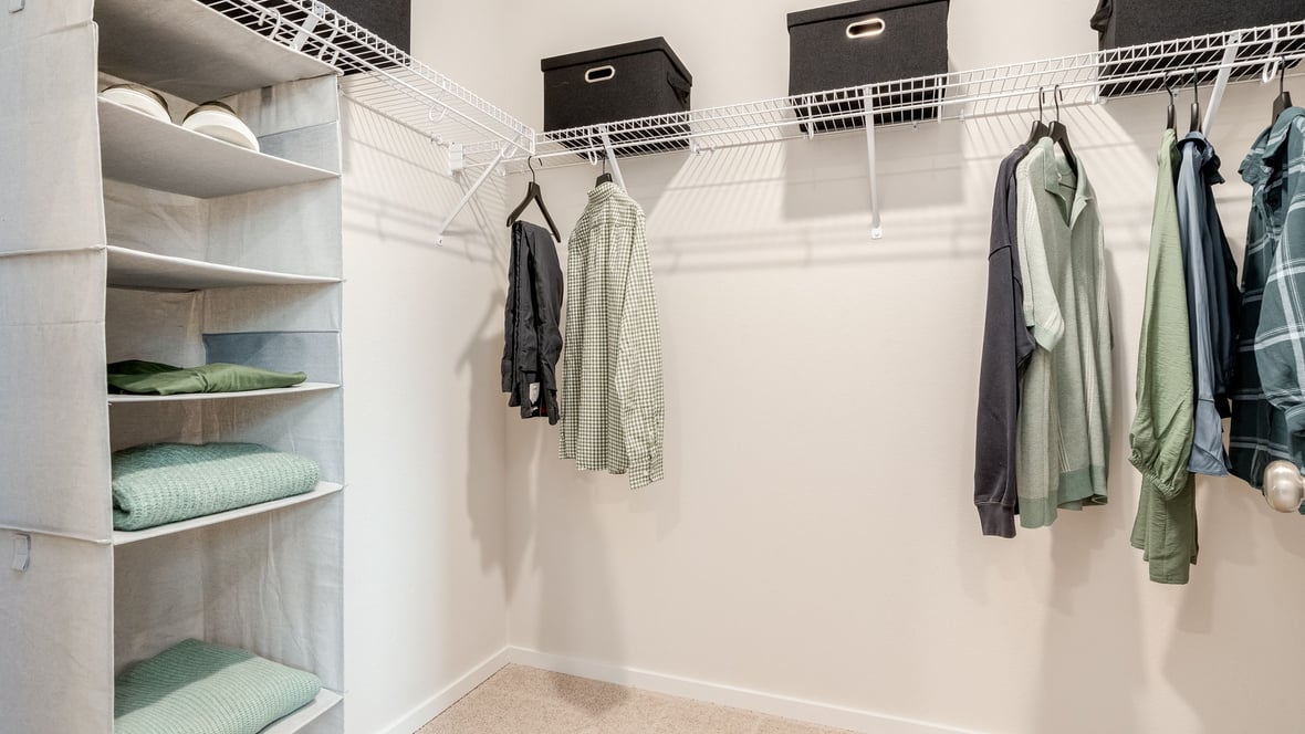 Primary bedroom walk-in closet with wire shelves