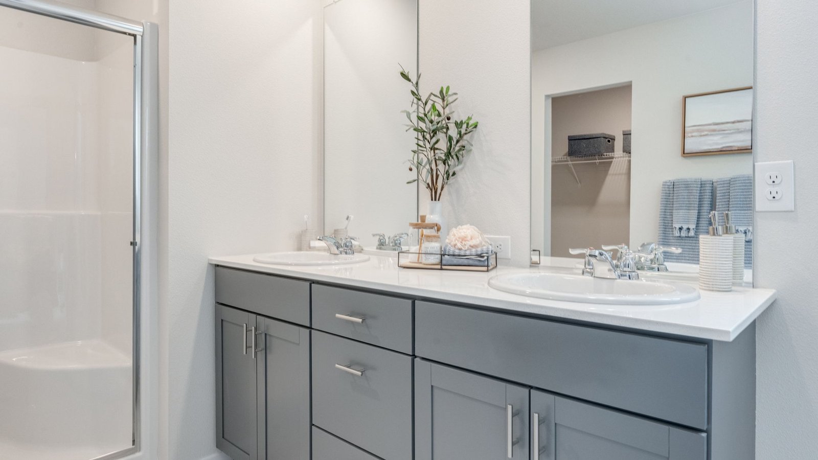 Primary bathroom with quartz counters and a walk-in shower