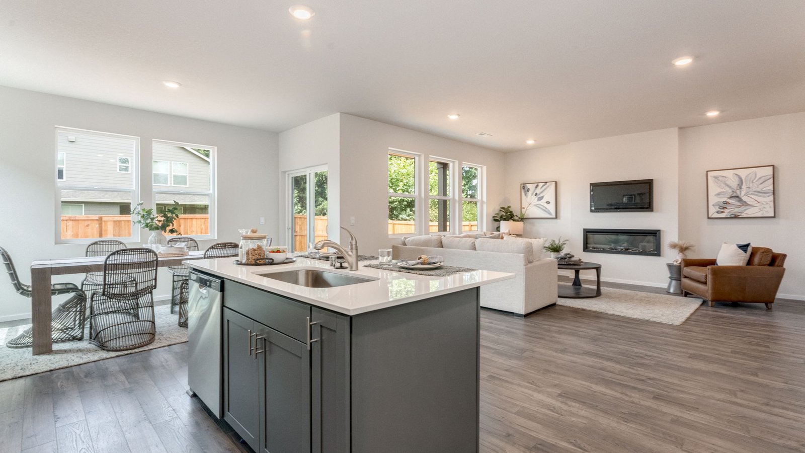 Kitchen with shaker cabinets, quartz counters, stainless steel appliances, pantry, and an island with a breakfast bar