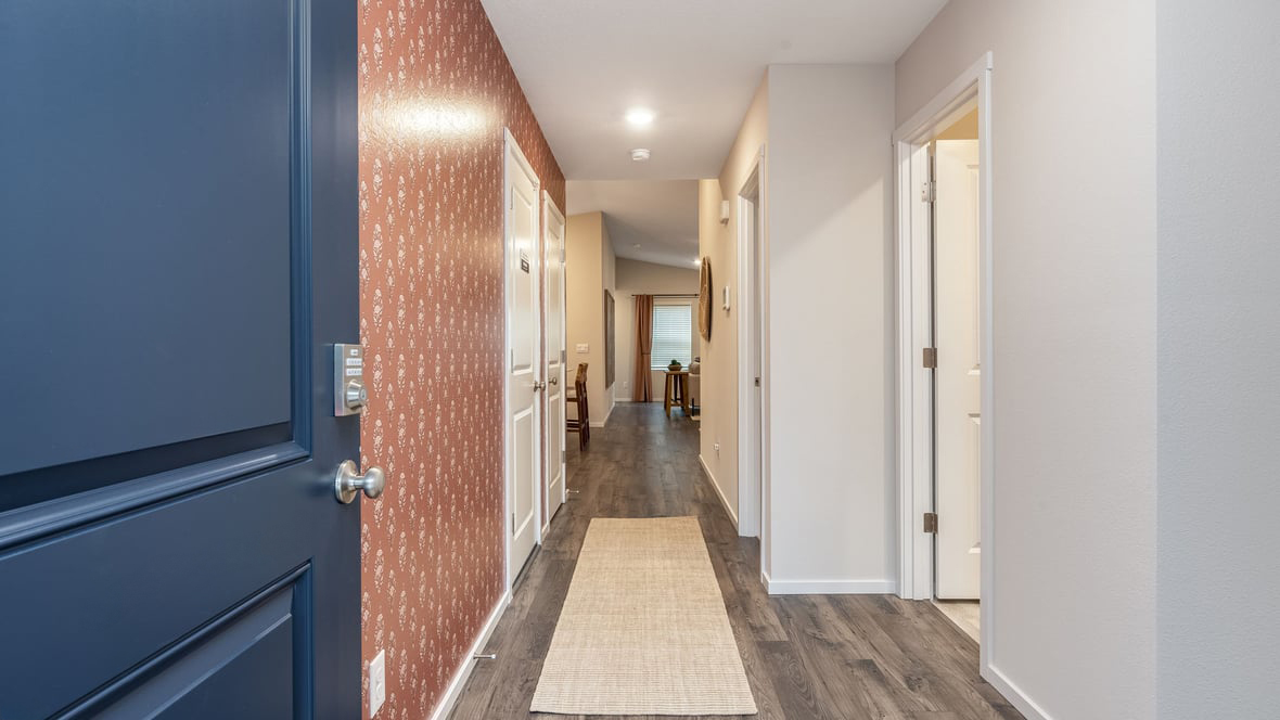 Entryway with a coat closet and laminate flooring
