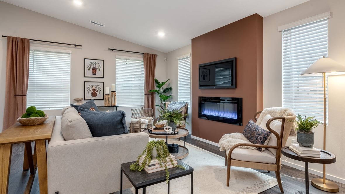 Great room with laminate flooring and an electric fireplace and vaulted ceilings