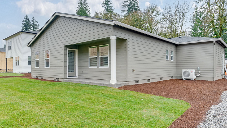 fully fenced backyard with sod lawn and a patio