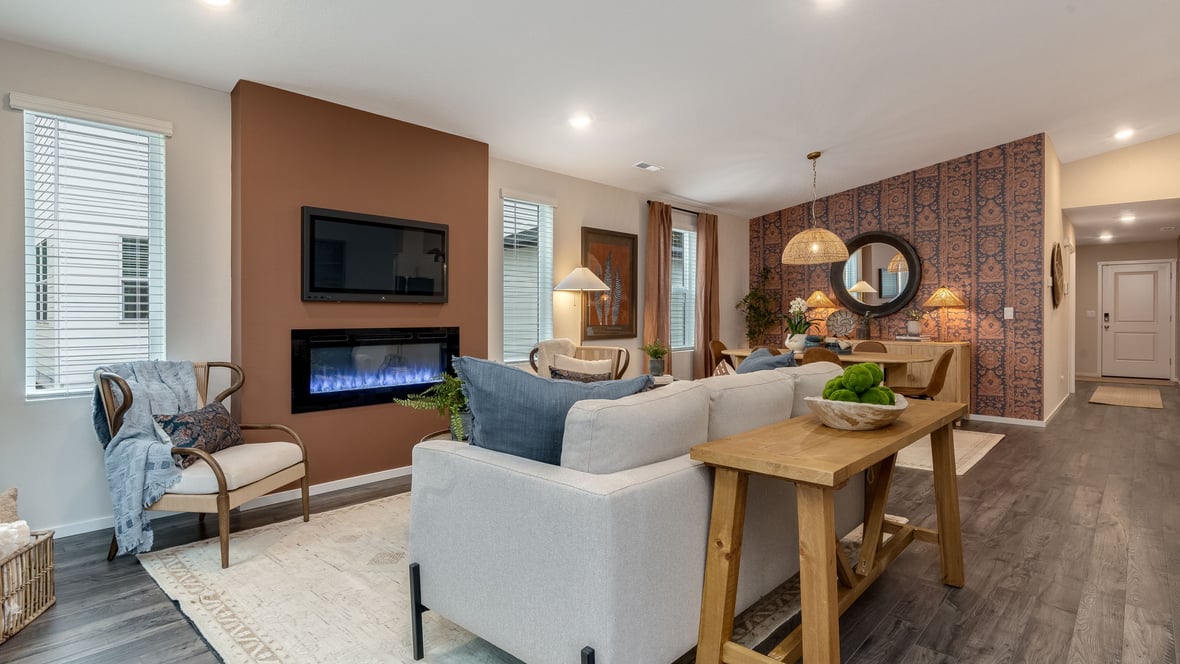 Great room with laminate flooring and an electric fireplace and vaulted ceilings