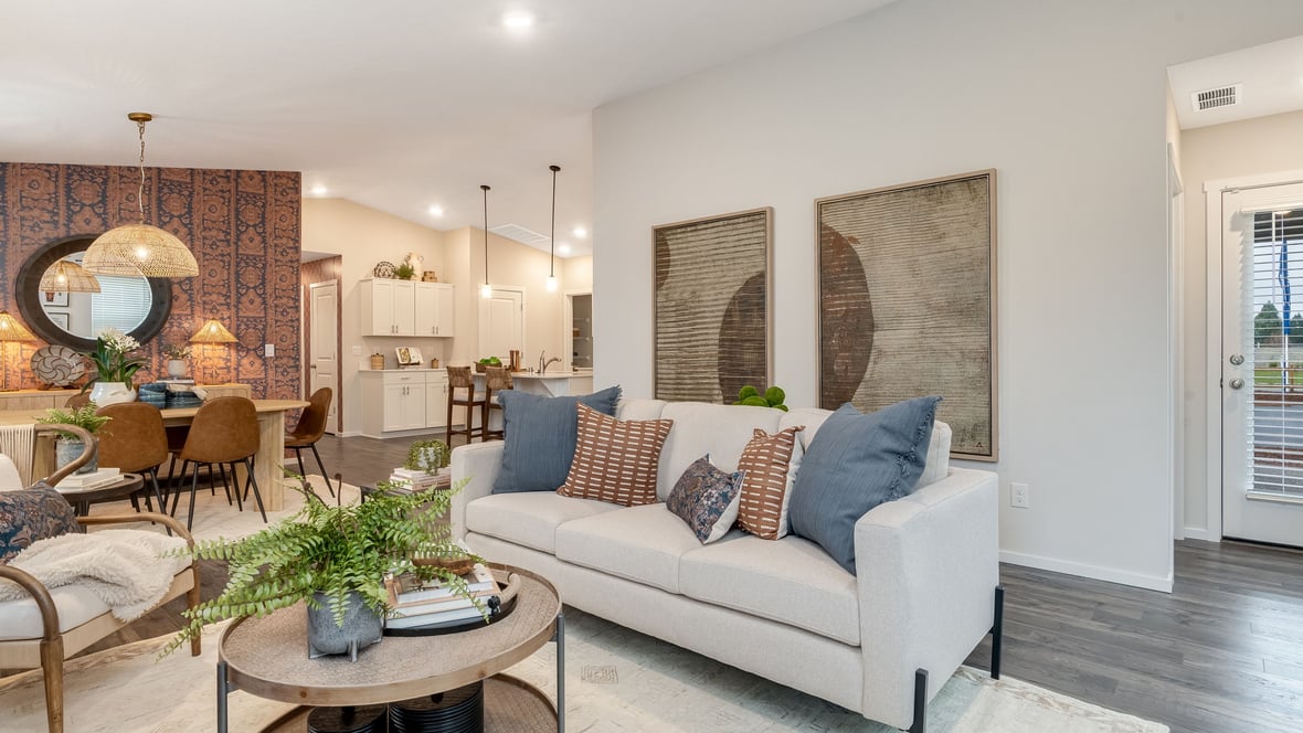 Great room with laminate flooring and an electric fireplace and vaulted ceilings