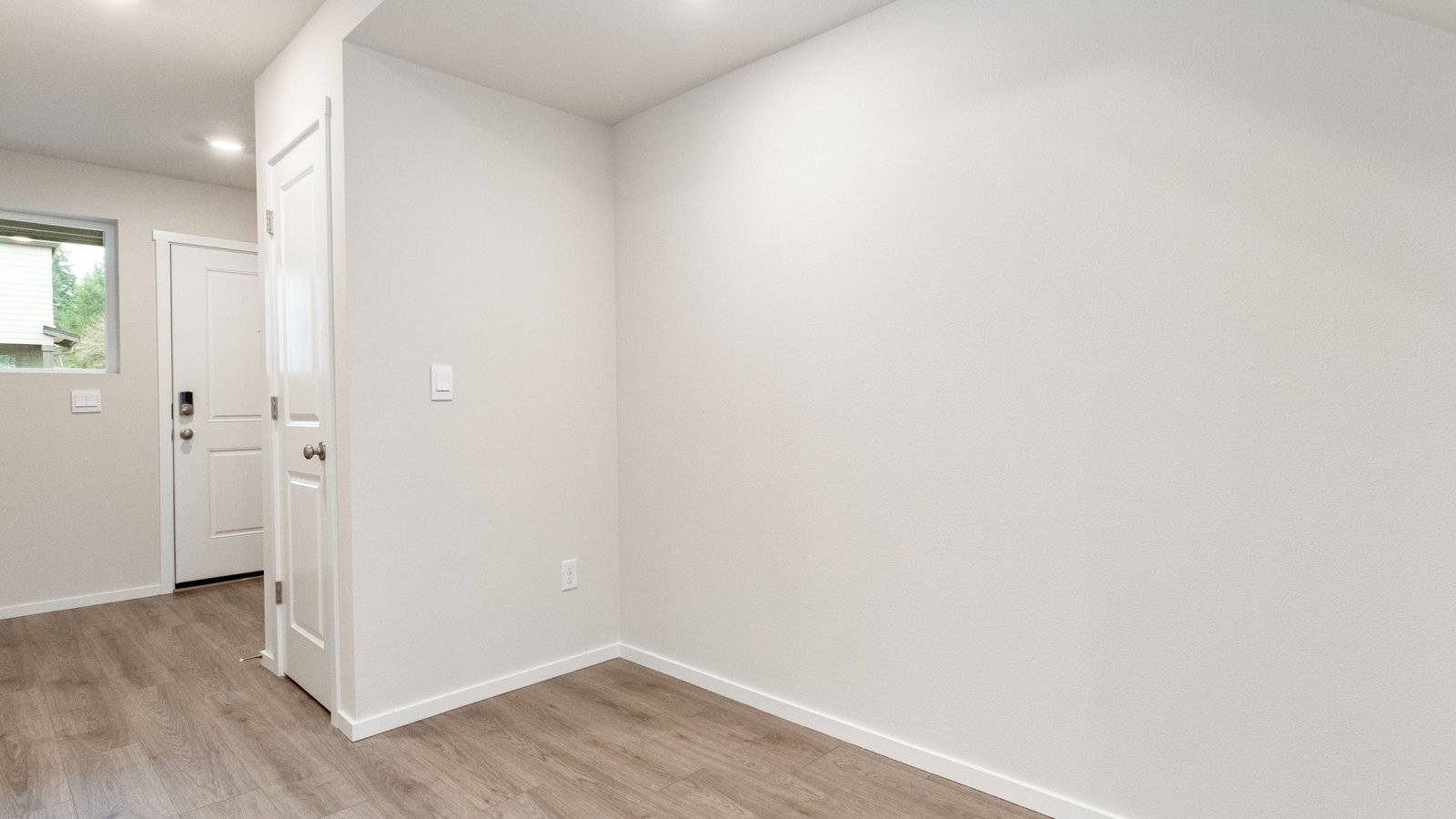 Entryway with a coat closet and laminate flooring