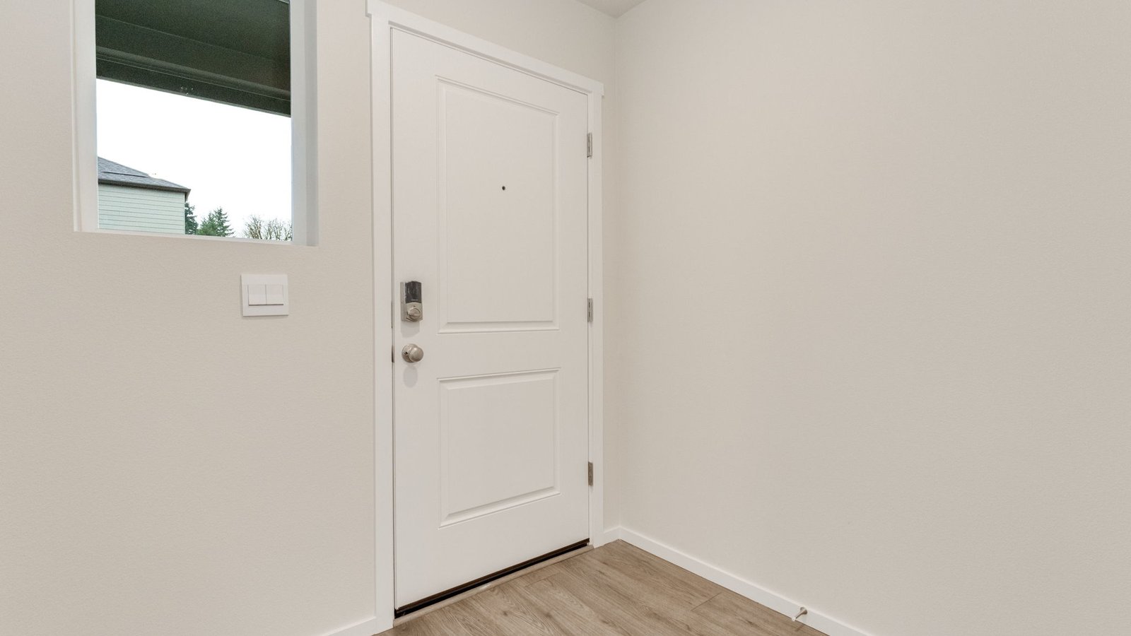 Entryway with a coat closet and laminate flooring