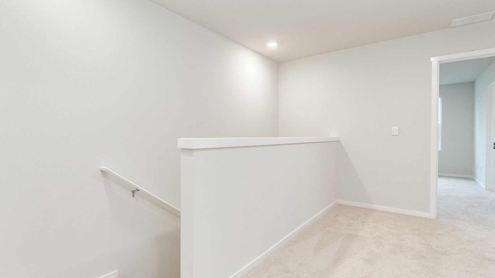 Hallway with wall-to-wall carpet