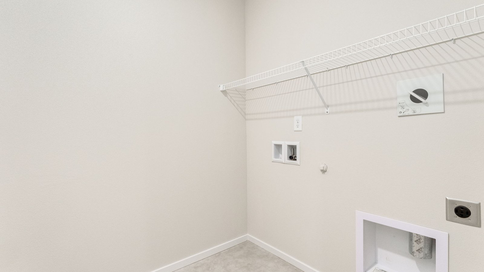 Laundry room with wire shelves and washer and dryer hookups