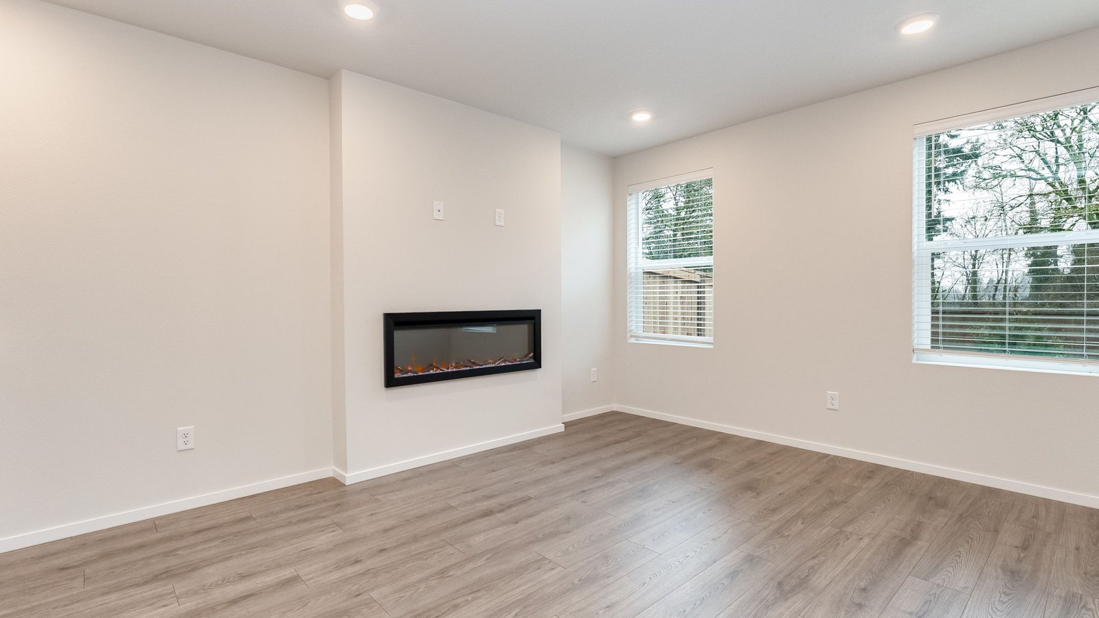 Great room with laminate flooring and an electric fireplace