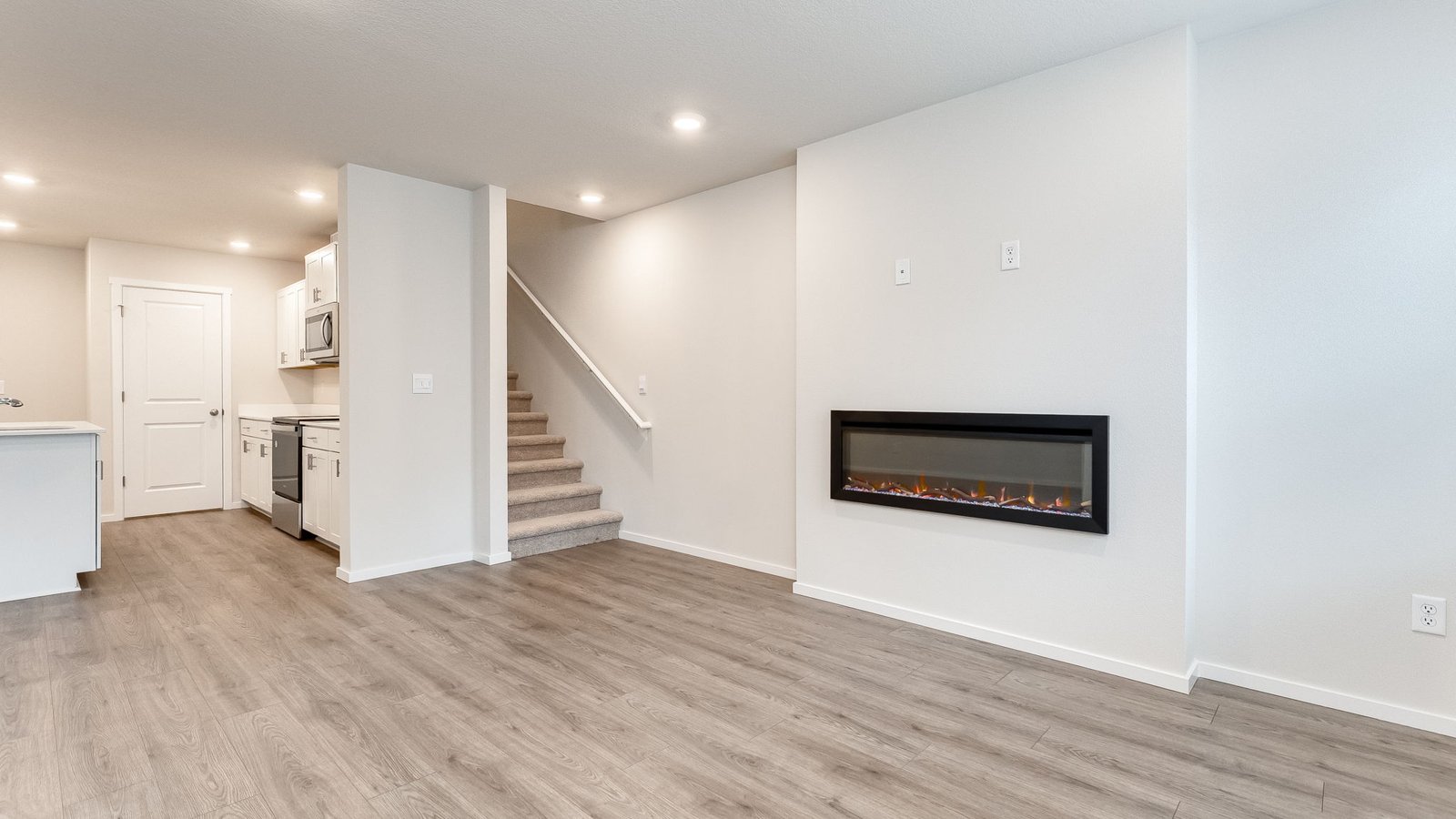Great room with laminate flooring and an electric fireplace
