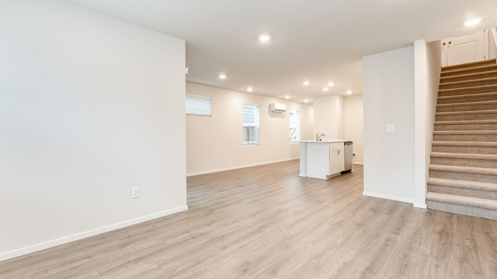 Great room with laminate flooring and an electric fireplace